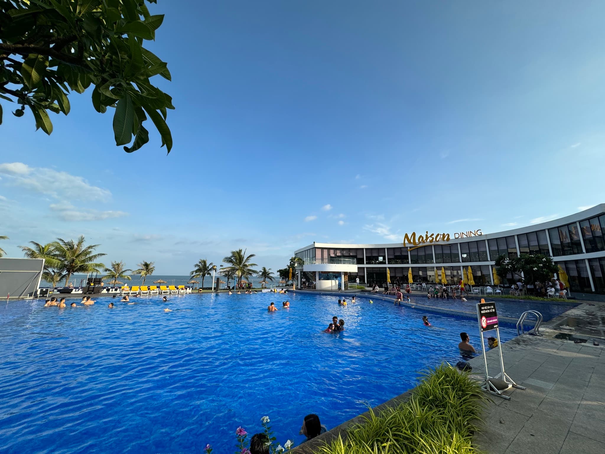 Large resort pool with the restaurant and ocean behind
